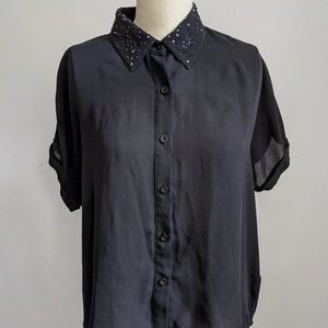 Sheer black open-back blouse with beaded collar